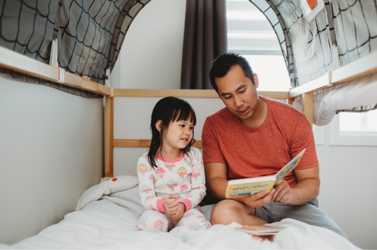 dad reading to daughter